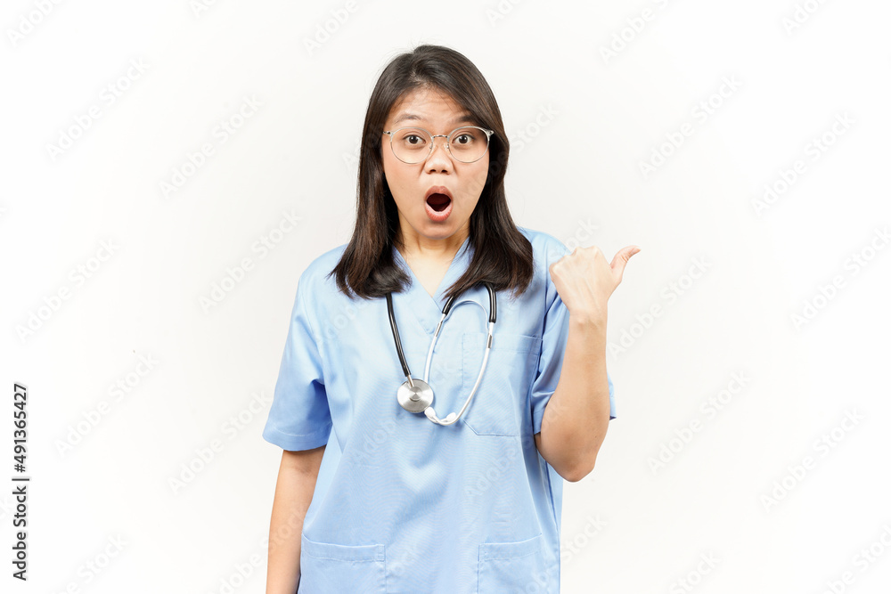 Showing and Pointing Product With Thumb Of Asian Young Doctor Isolated On White Background Showing and Pointing Product With Thumb Of Asian Young Doctor Isolated On White Background