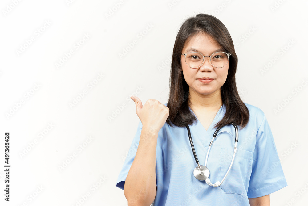 Showing and Pointing Product With Thumb Of Asian Young Doctor Isolated On White Background Showing and Pointing Product With Thumb Of Asian Young Doctor Isolated On White Background
