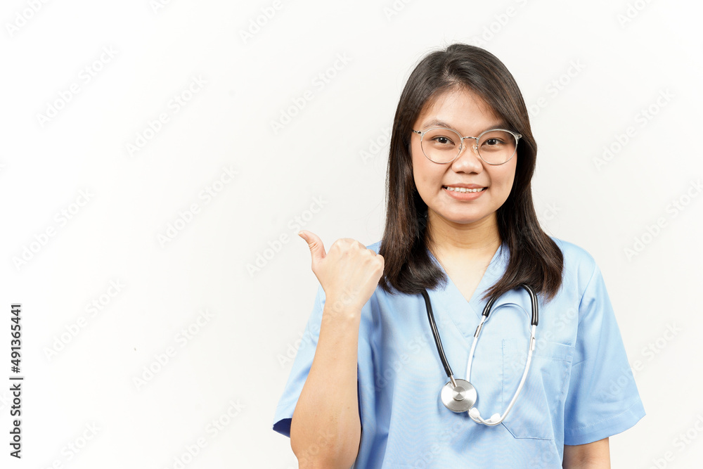 Showing and Pointing Product With Thumb Of Asian Young Doctor Isolated On White Background Showing and Pointing Product With Thumb Of Asian Young Doctor Isolated On White Background