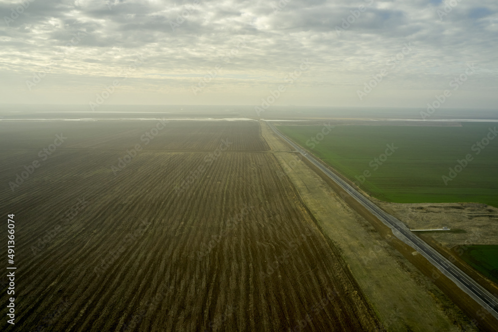 steppe landscape with expensive arable land and clouds