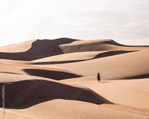 Mulher caminhando em Dunas de areia nas Dunas do Rosado, Rio grande do Norte, Brasil  photo