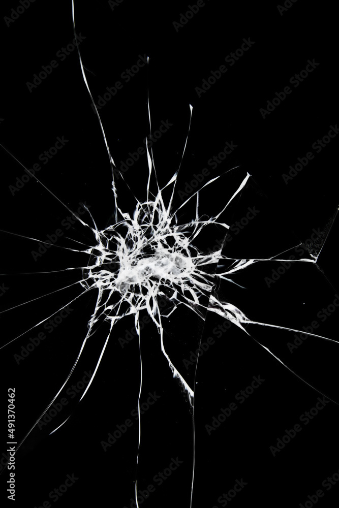 Broken glass with cracks. Blow on the smartphone's safety glass. Broken glass with cracks. Blow on the smartphone's safety glass.