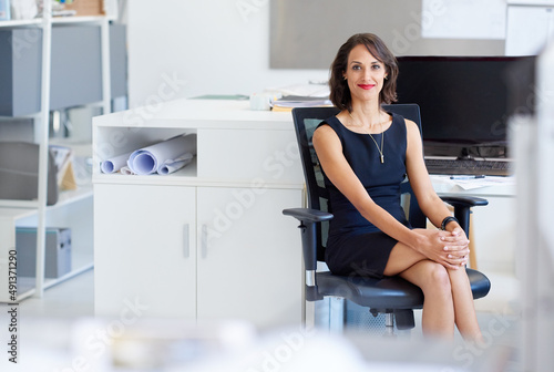 Ready to achieve even greater success. Portrait of a young designer sitting at her workstation in an office.