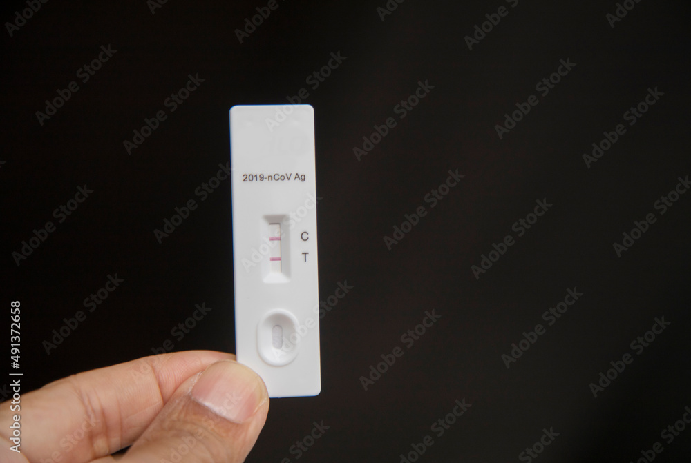Rapid antigen test (RAT) with COVID-19 Ag inscription.2 stripes showing a POSITIVE result. Rapid antigen test (RAT) with COVID-19 Ag inscription.2 stripes showing a POSITIVE result.