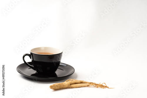 cup of ginseng tea with cinnamon white background