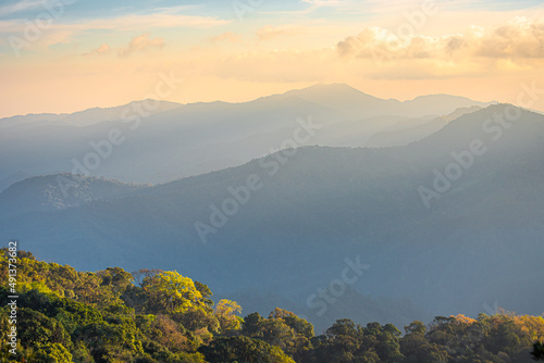 Panorama of Beautiful scenery landscape sunset on mountain peak tropical rainforest. rainforest in the worm summer season at north of Thailand. Jurassic forest walk back to the Jurassic world.