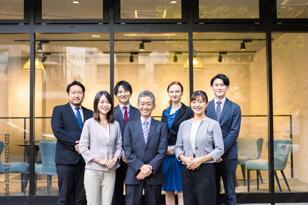 オフィスの前で並ぶビジネスパーソン