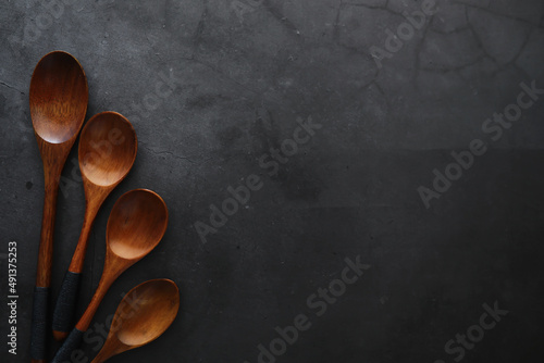 Wooden spoons with spices. A mixture of peppers and spices. Fragrant herbs for food.