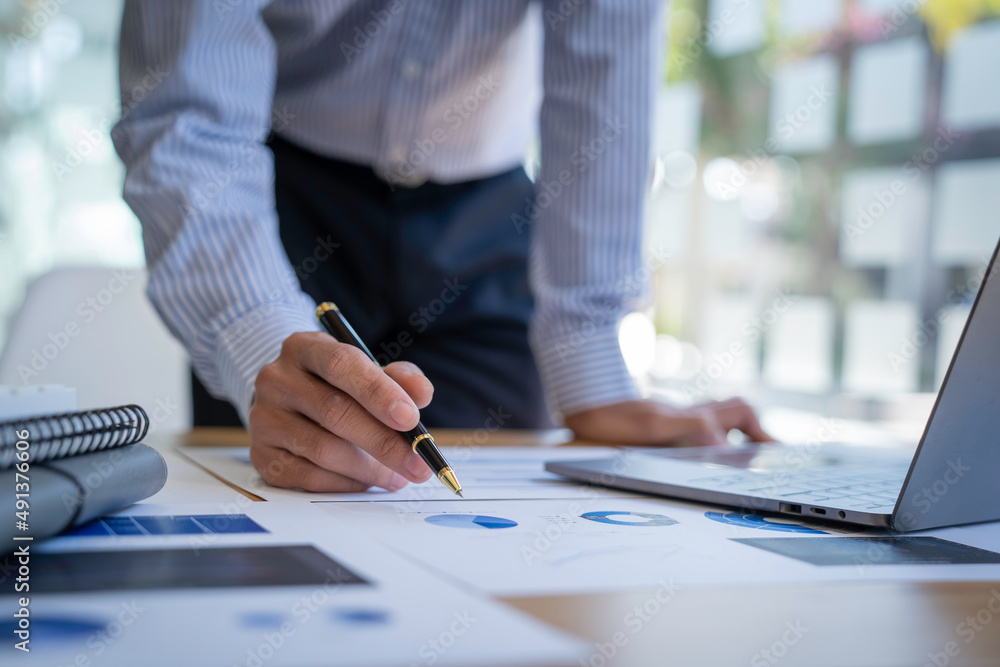 Businessman sitting at a desk financial data analysis and market growth report graph and investment results, analytical concepts and financial investments. Businessman sitting at a desk financial data analysis and market growth report graph and investment results, analytical concepts and financial investments.