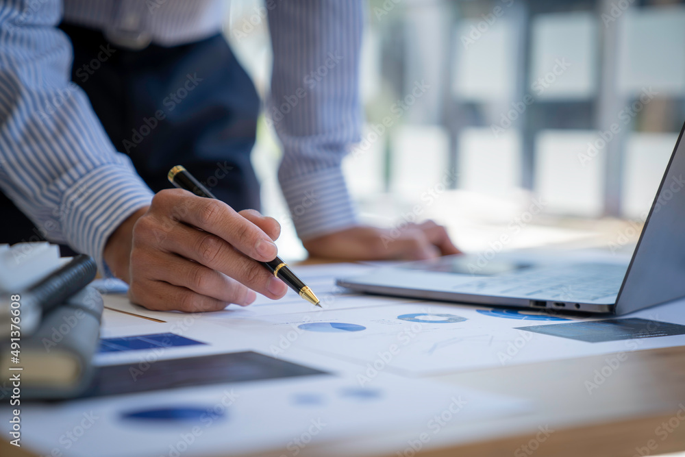 Businessman sitting at a desk financial data analysis and market growth report graph and investment results, analytical concepts and financial investments. Businessman sitting at a desk financial data analysis and market growth report graph and investment results, analytical concepts and financial investments.