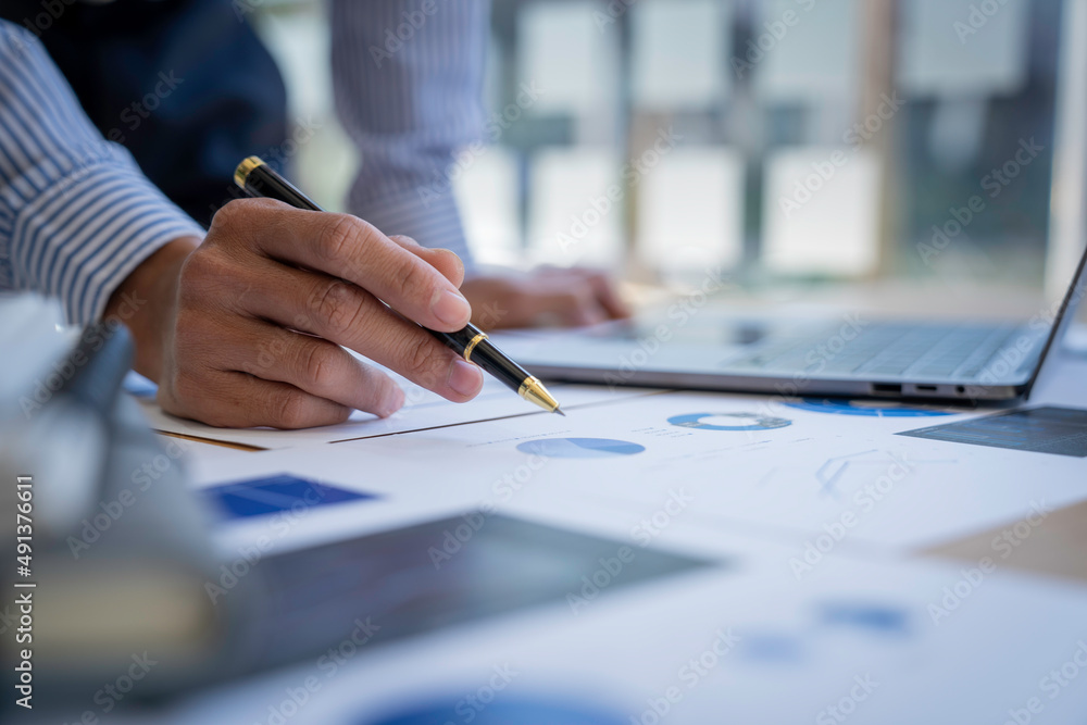 Businessman sitting at a desk financial data analysis and market growth report graph and investment results, analytical concepts and financial investments. Businessman sitting at a desk financial data analysis and market growth report graph and investment results, analytical concepts and financial investments.