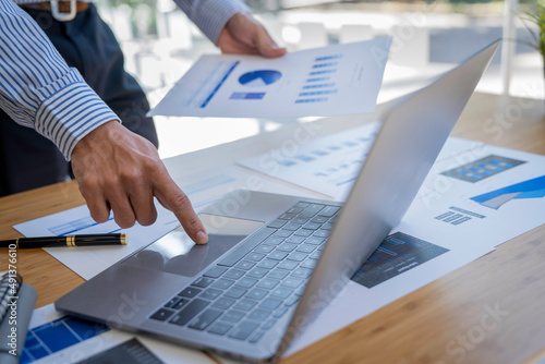 Businessman sitting at a desk financial data analysis and market growth report graph and investment results, analytical concepts and financial investments.