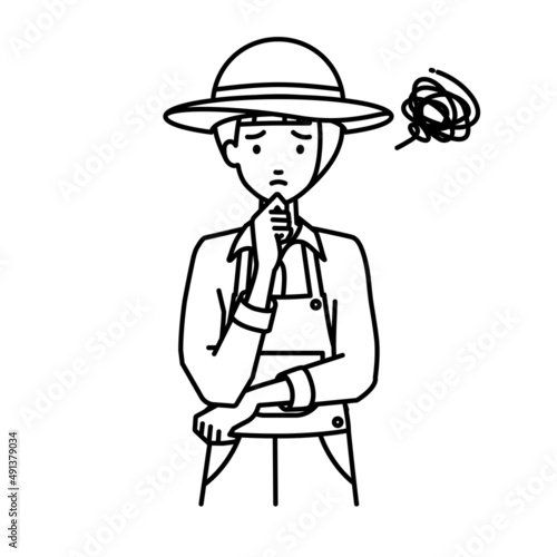 立って手をあごにあてて困っている農家の女性