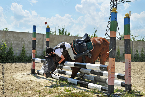 Konstfotografi Falling rider with a horse while overcoming a barrier