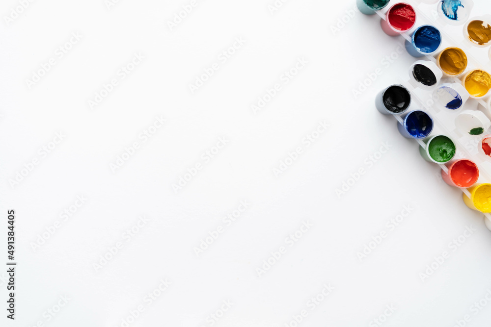 Flat composition a set of multi-colored paints in jars. Space for the text. Flat composition a set of multi-colored paints in jars. Space for the text.