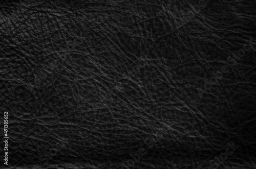 Closeup of seamless black leather texture background, surface material for fashion dark pattern decoration.