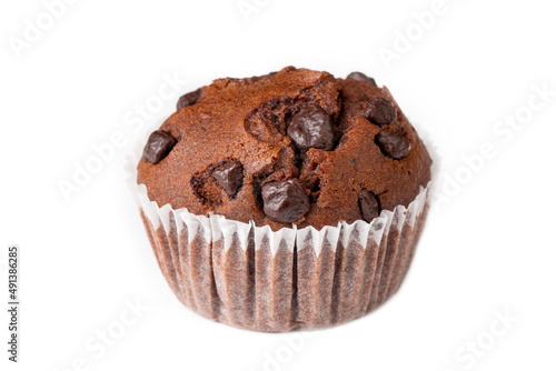 Handmade cocoa chocolate chip muffin on the white background.