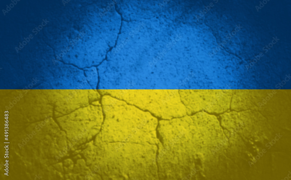 national, patriotic and background concept - cracked stone wall with peeling stucco painted in colors of flag of ukraine