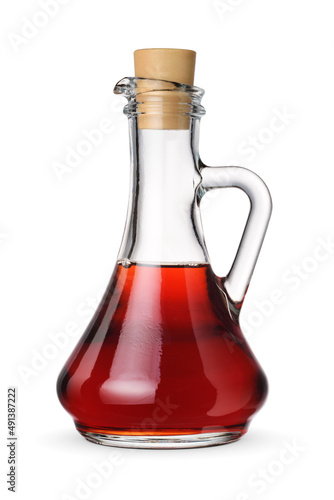 Glass jar with red grape vinegar isolated on white. photo