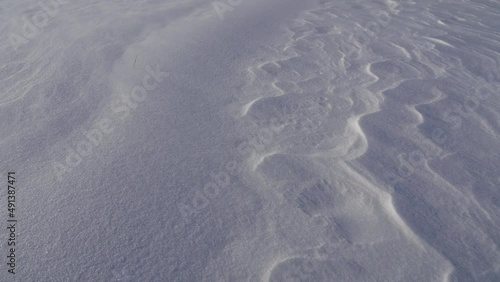movement of snow particles on a white snow fancy cover, footprints in snow