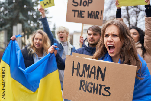 Group of young caucasian people manifesting against Ukrainian war