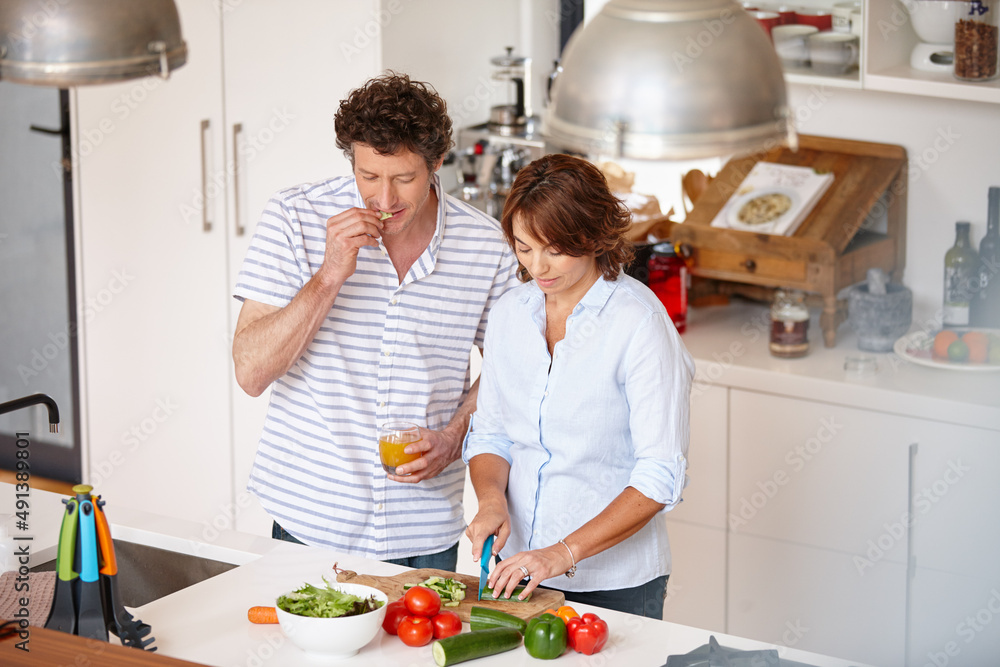 Cooking up something healthy. Shot of a happy mature couple cooking a healthy meal together at home.