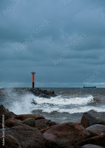 lighthouse by the sea on a windy cloudy day