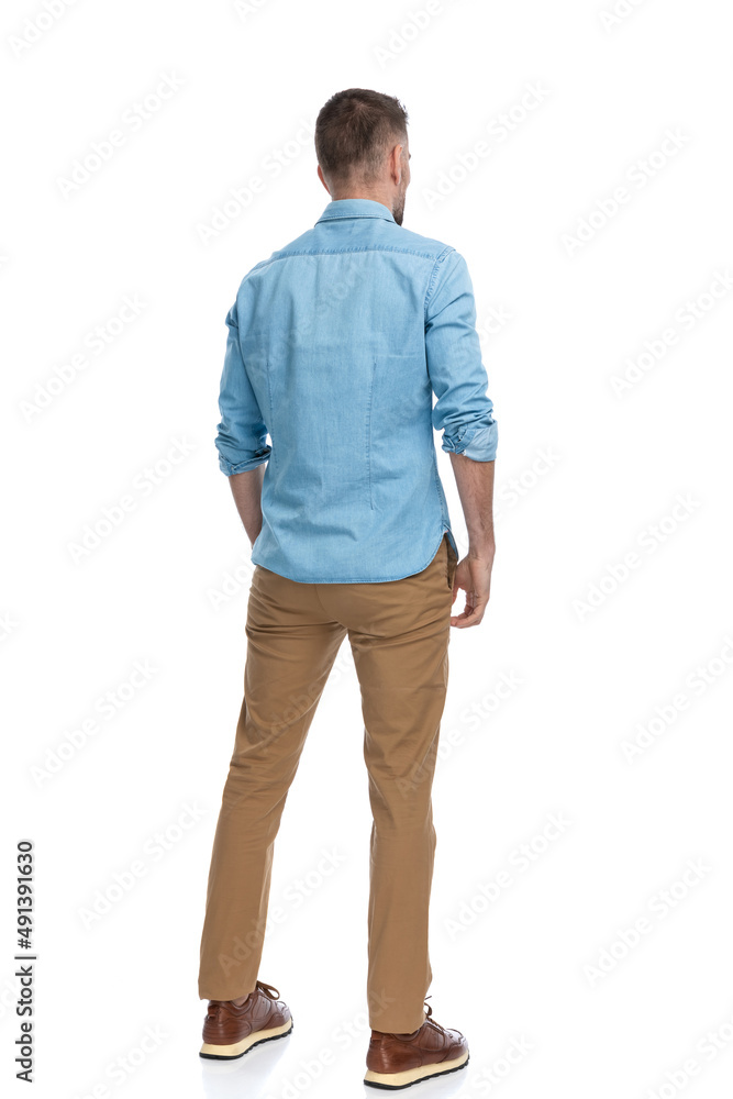 man in his forties standing in a back view position man in his forties standing in a back view position