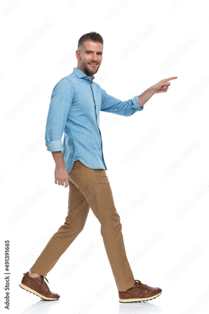 bearded middle aged guy smiling and pointing finger while walking bearded middle aged guy smiling and pointing finger while walking