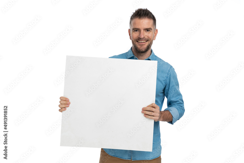 proud unshaved man holding board and presenting advertisement proud unshaved man holding board and presenting advertisement