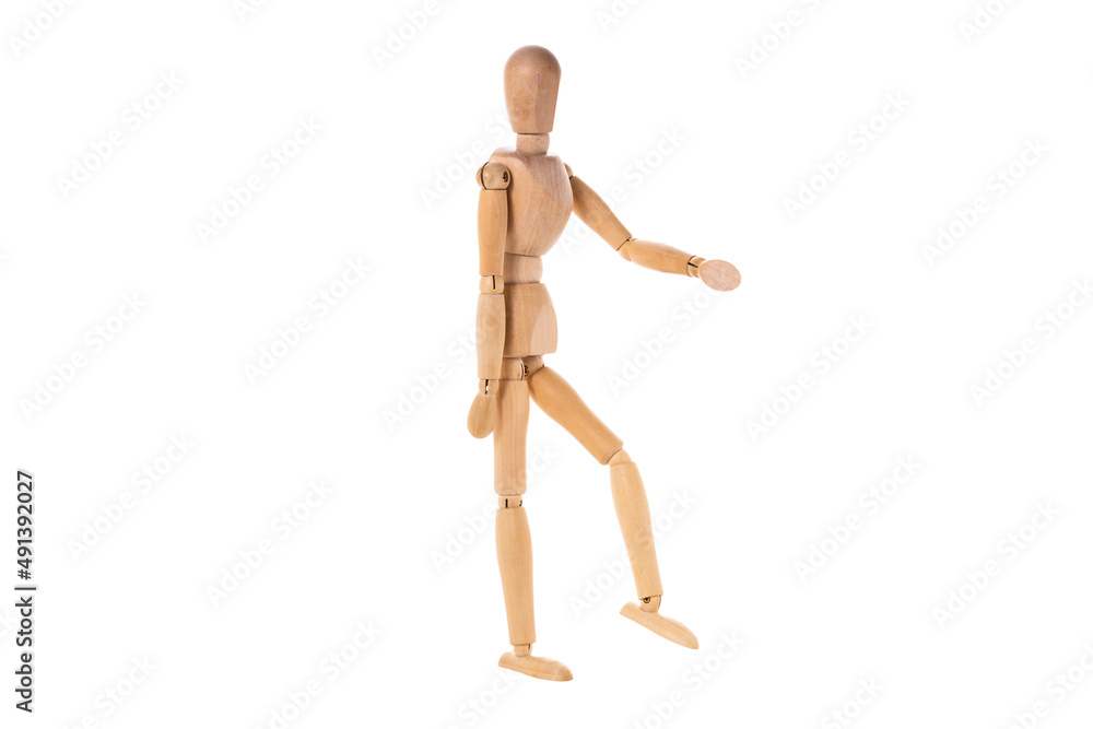 wooden man stands with one arm and leg raised isolated on white background wooden man stands with one arm and leg raised isolated on white background