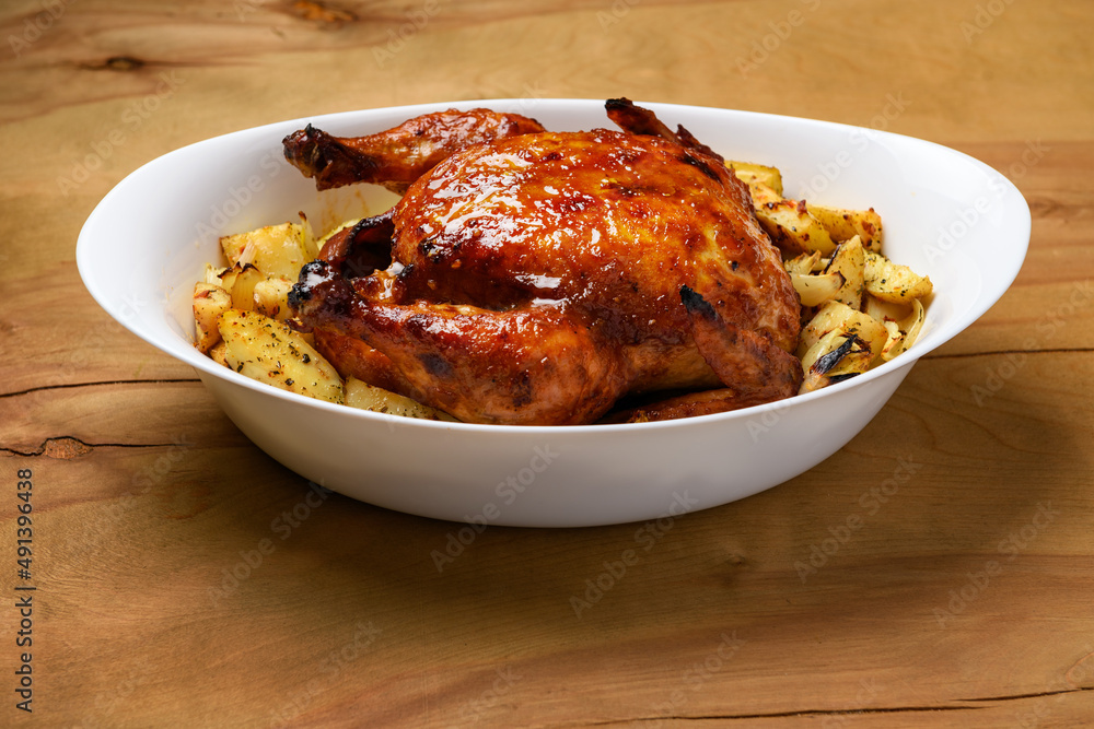 fried chicken meat and roasted potatoes, tasty food on a wooden background fried chicken meat and roasted potatoes, tasty food on a wooden background