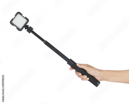 hand holding LED Video Camera Light square panel lamp isolated on white background