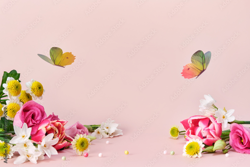 Beautiful spring and summer flowers and butterflies on pink background. Spring Easter or summer holiday background Beautiful spring and summer flowers and butterflies on pink background. Spring Easter or summer holiday background