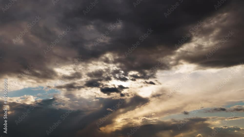 bright sunlight through a dark dramatic sky with thunderclouds, extreme weather, timelapse
bright sunlight through a dark dramatic sky with thunderclouds, extreme weather, timelapse