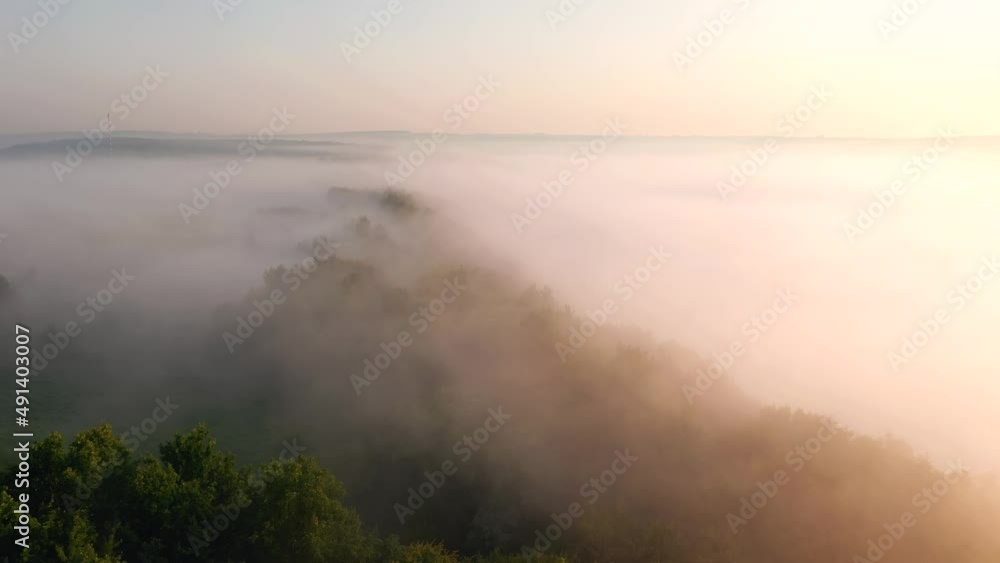 A shot from a drone over a thick fog that covered the plain before dawn. Filmed in UHD 4k video. A shot from a drone over a thick fog that covered the plain before dawn. Filmed in UHD 4k video.