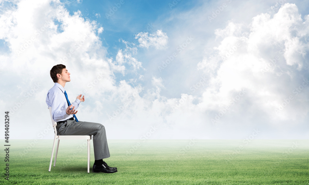 businessman meditates on office chair businessman meditates on office chair