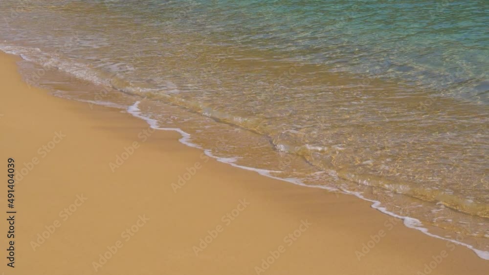 Gently clear water waves in slow motion rolling into empty sandy beach, 180fps Gently clear water waves in slow motion rolling into empty sandy beach, 180fps