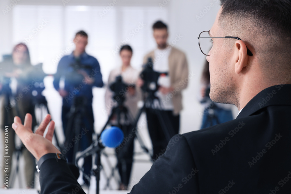 Businessman giving interview to journalists at official event, closeup Businessman giving interview to journalists at official event, closeup