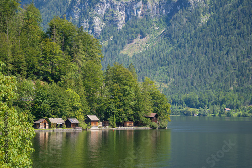Small wooden houses on the lake near Hallstatt mountain village in the Austrian Alps in summer, Austria