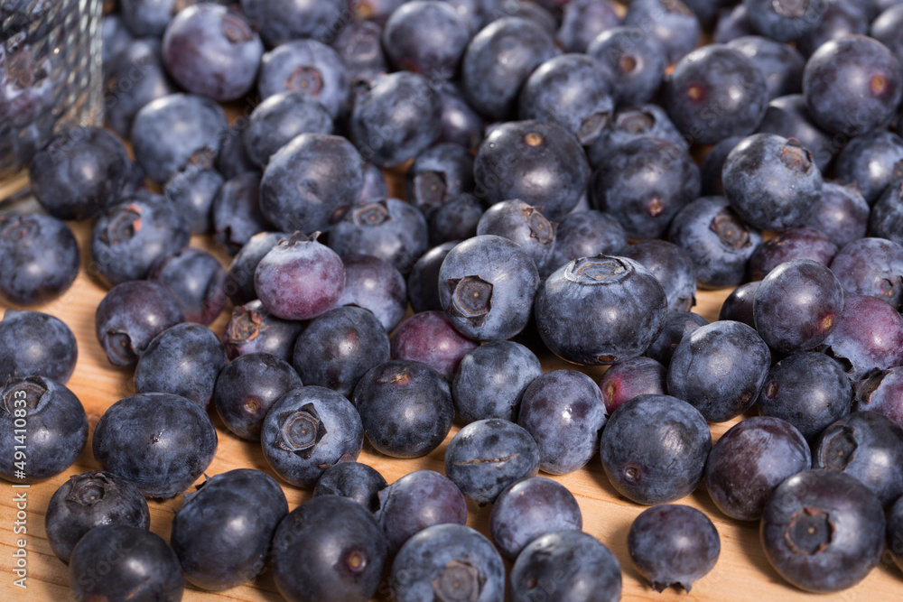 Fototapeta premium Fresh delicious blueberries on wooden table. High quality photo