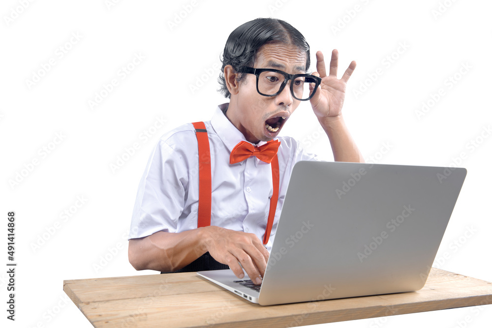 Asian nerd with an ugly face using laptop Asian nerd with an ugly face using laptop