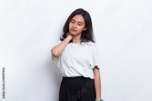 beautiful asian young woman with sore throat neck and shoulder pain isolated on a white background 