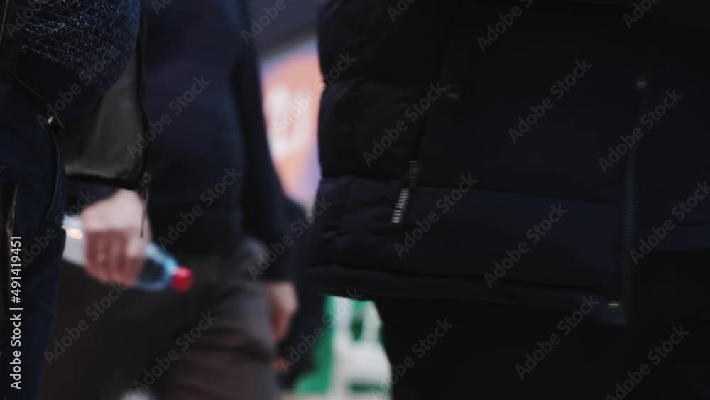 A crowd of people in the large, bright lobby of the business center.