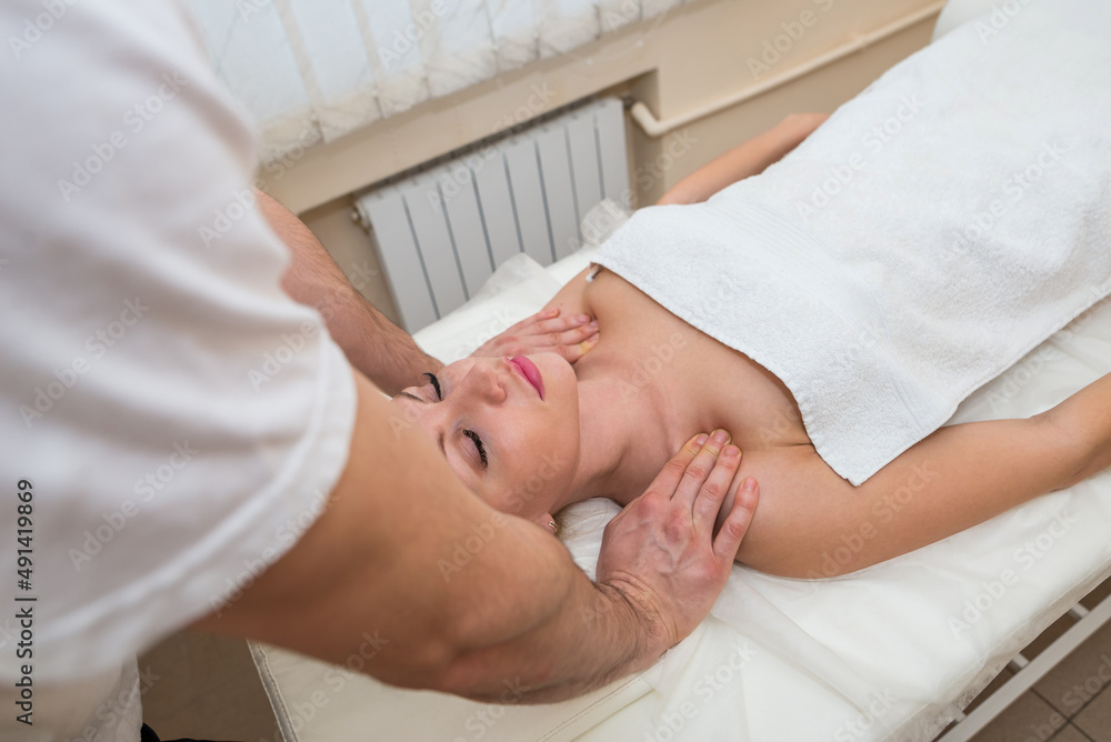  woman lying in spa getting shoulder and neck massage