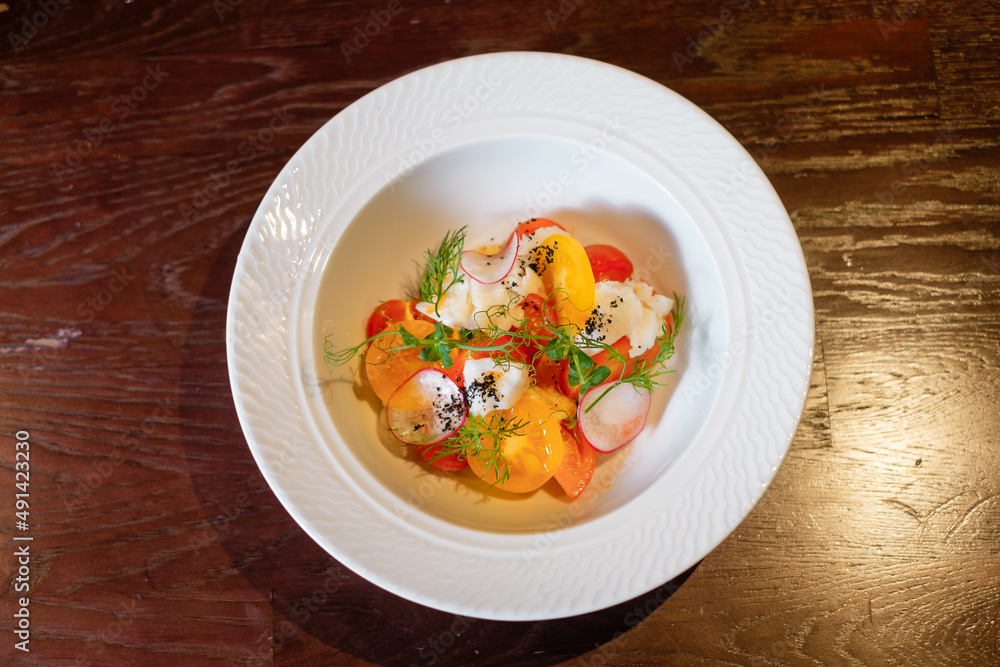 Salad with herbs, radishes and tomatoes. Salad with herbs, radishes and tomatoes.