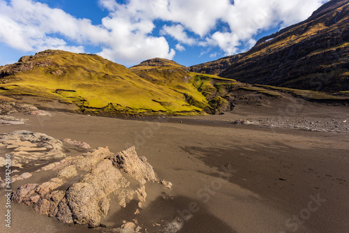 Dark beach in Osin Bay and steep mountain slopes. Saksun, Faroe Islands. photo