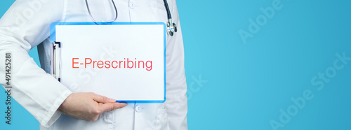 E-Prescribing (Electronic Prescribing). Doctor with stethoscope holds blue clipboard. Text is written on document. photo