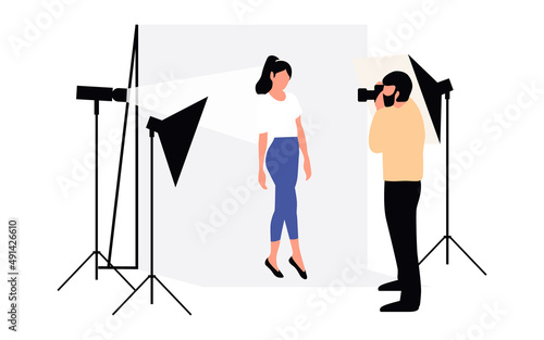 Professional photographers taking pictures. Men and woman models posing in professional photography studio with cameras and light tripods.