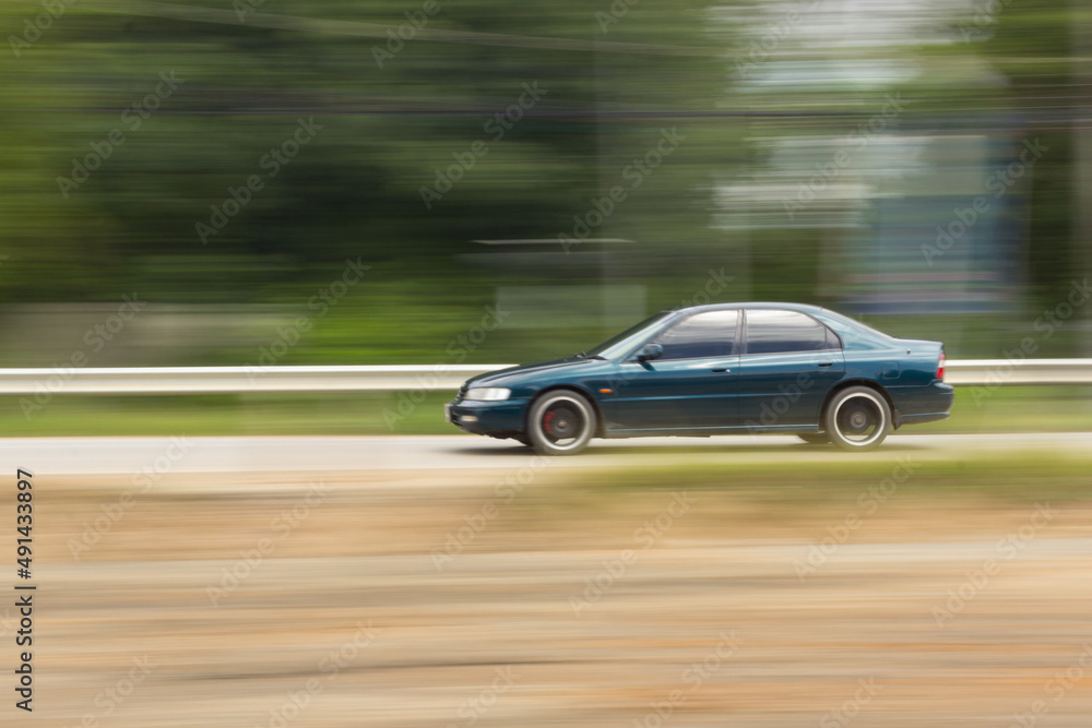 Green Car panning speed on road, Thailand asia